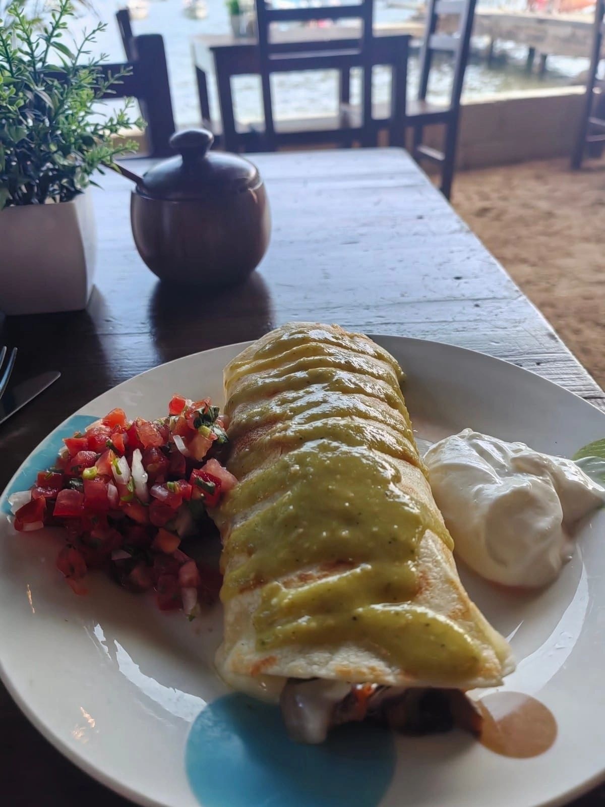 Mediterranean dish with green sauce beachside